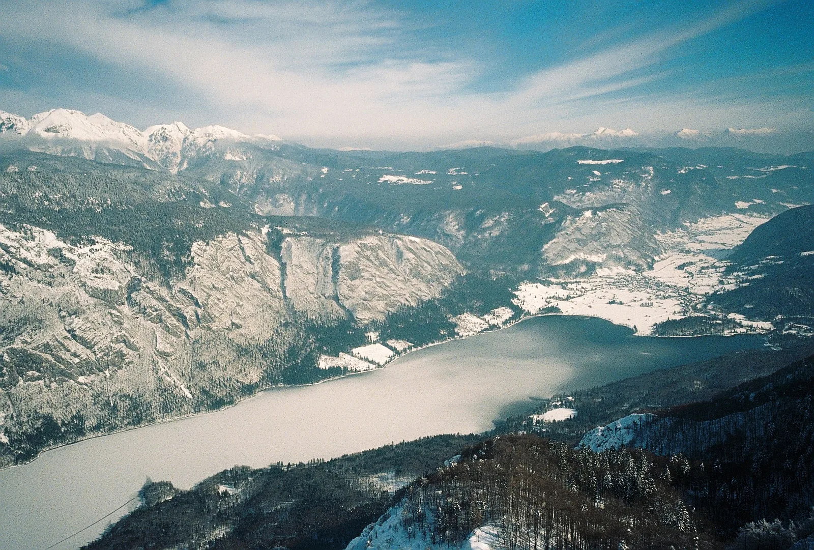Der Bohinjer See von oben, im Hintergrund die verschneiten Julischen Alpen