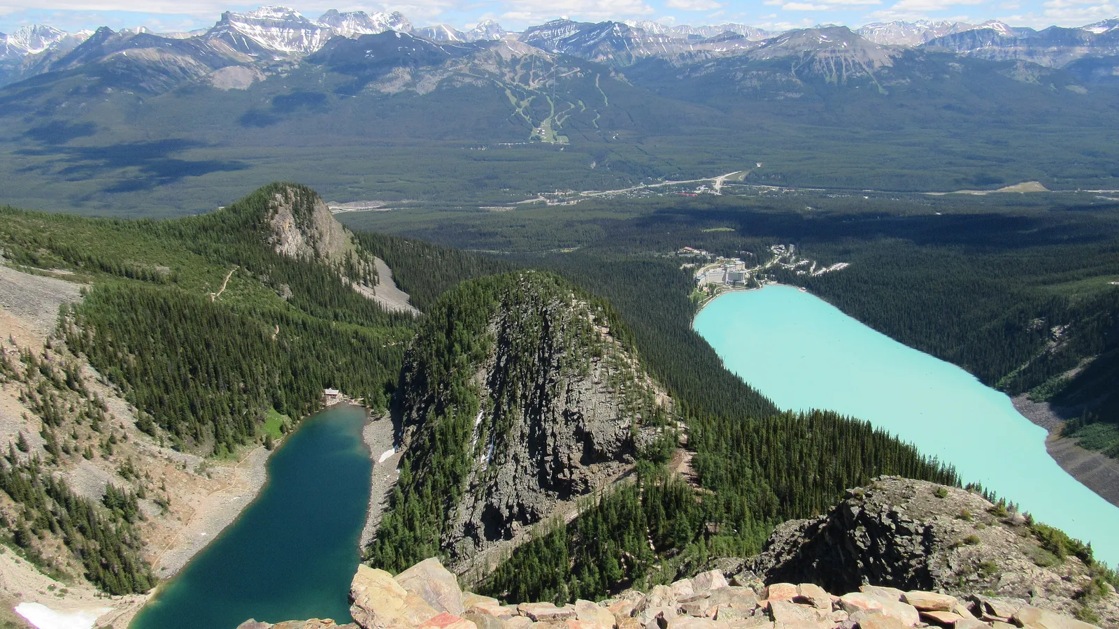 Blick vom Devil's Thumb im Banff-Nationalpark: links unten der Lake Agnes, in der Mitte der Big Beehive, rechts der türkisfarbene Lake Louise mit dem Hotel.